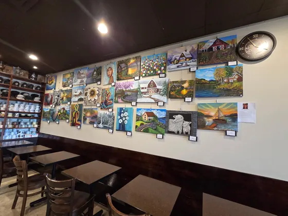 The Juleanne Collection hanging on the wall inside Sips Coffee & Cafe in Rochester, NY